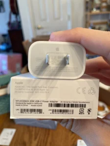 Matching serial numbers on Apple 20W adapter body and retail packaging.